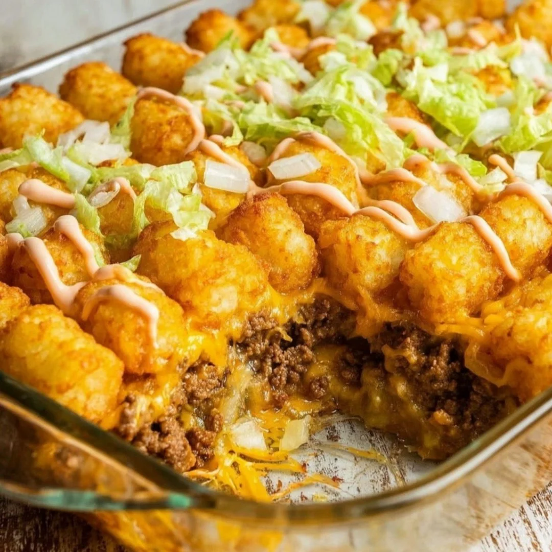 Big Mac Tater Tot Casserole topped with melted cheese and fresh toppings
