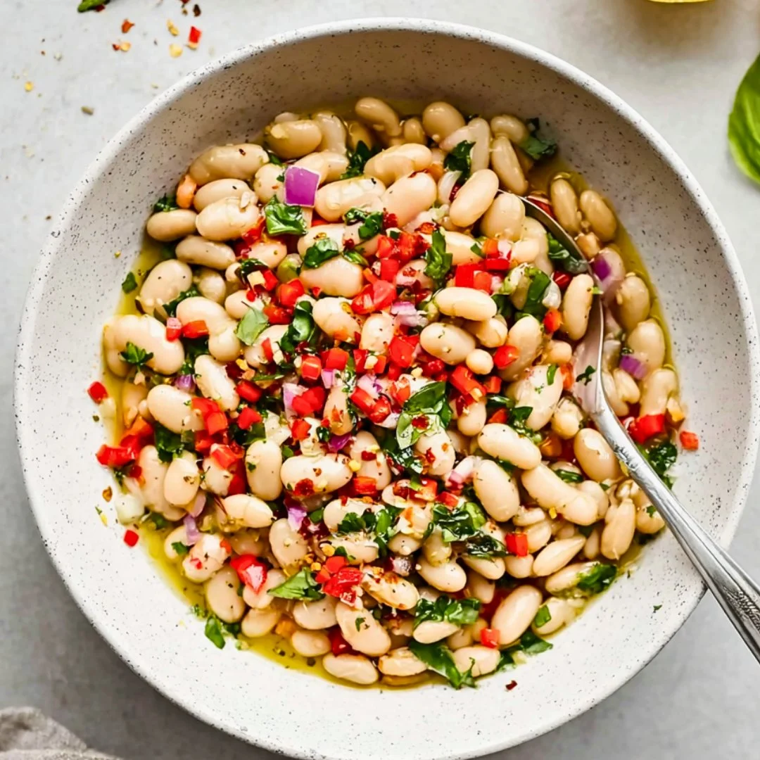 Blue_Salt_Trick_for_Men_Recipe_05 A bright, fizzy blue beverage with granulated salt crystals and a clear jar on a granite surface.