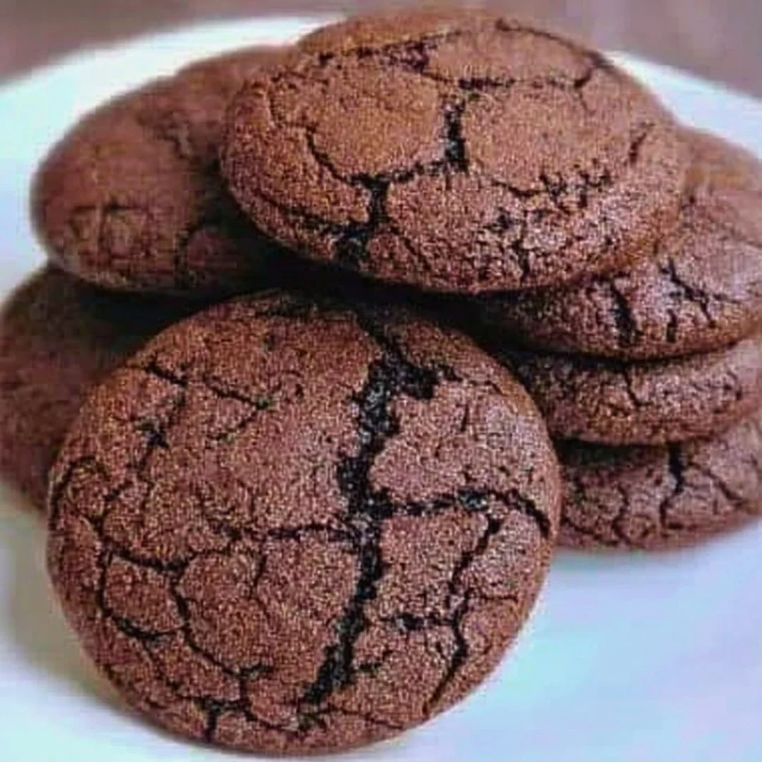 Freshly baked chewy chocolate cookies on a cooling rack