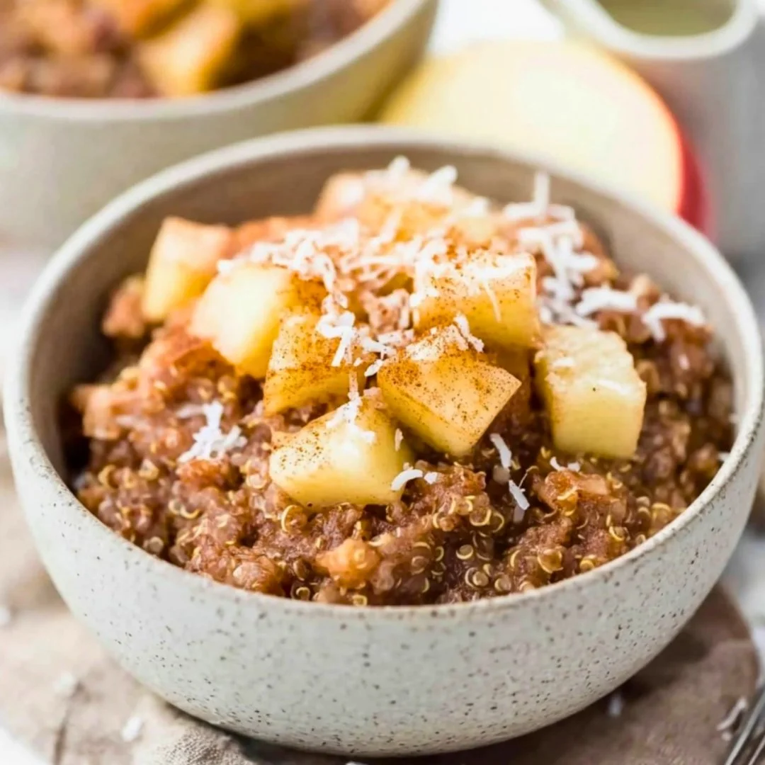 Bowl of Cinnamon Apple Breakfast Quinoa topped with apples and cinnamon