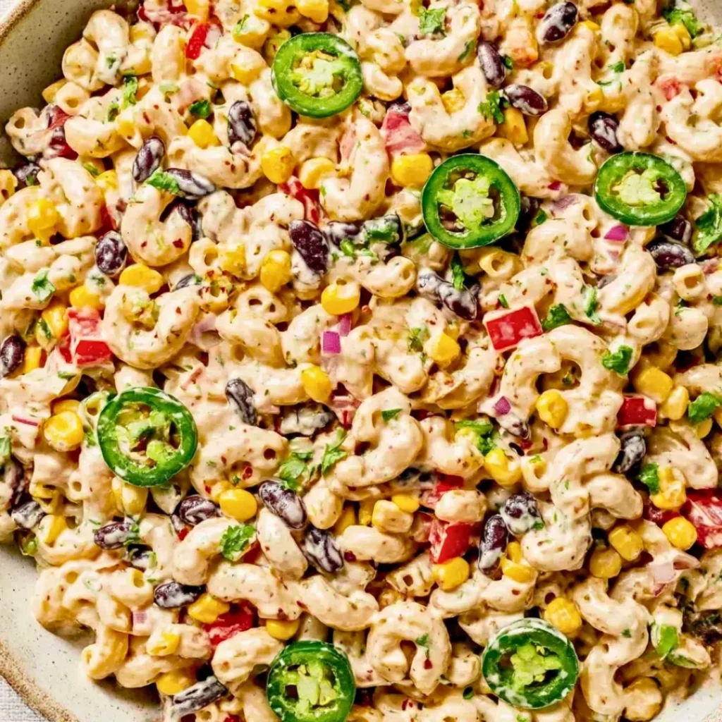 A bright, fizzy blue beverage with granulated salt crystals and a clear jar on a granite surface.