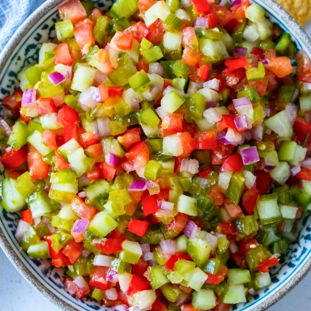 A colorful jar of Pickle of the Rooster with vibrant spices and fresh ingredients.