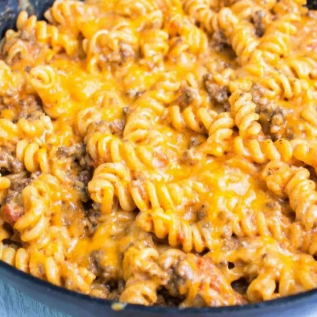 Blue_Salt_Trick_for_Men_Recipe_05 A bright, fizzy blue beverage with granulated salt crystals and a clear jar on a granite surface.