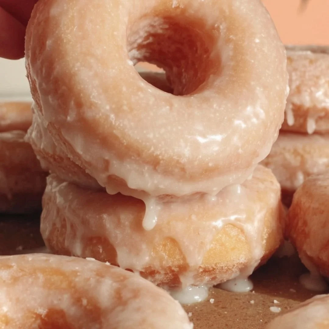 Homemade glazed donuts fresh out of the oven - a delicious, sweet treat.