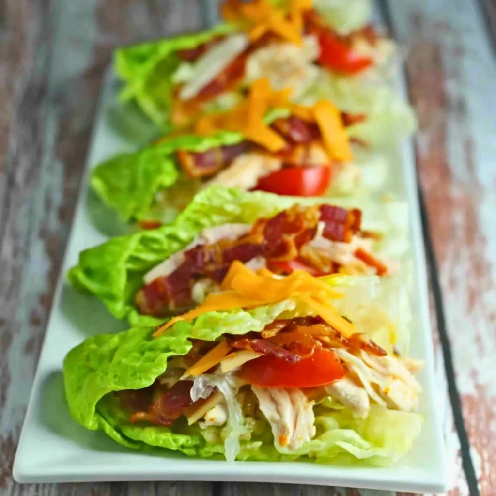 A bright, fizzy blue beverage with granulated salt crystals and a clear jar on a granite surface.